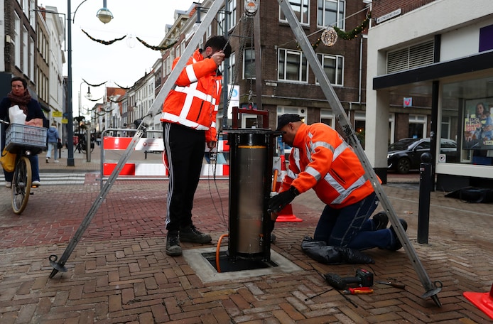 Met een speciale hijsinstallatie halen de reparateurs de paal uit de grond om de schade te repareren. Met hetzelfde systeem wordt deze ook weer teruggezet.